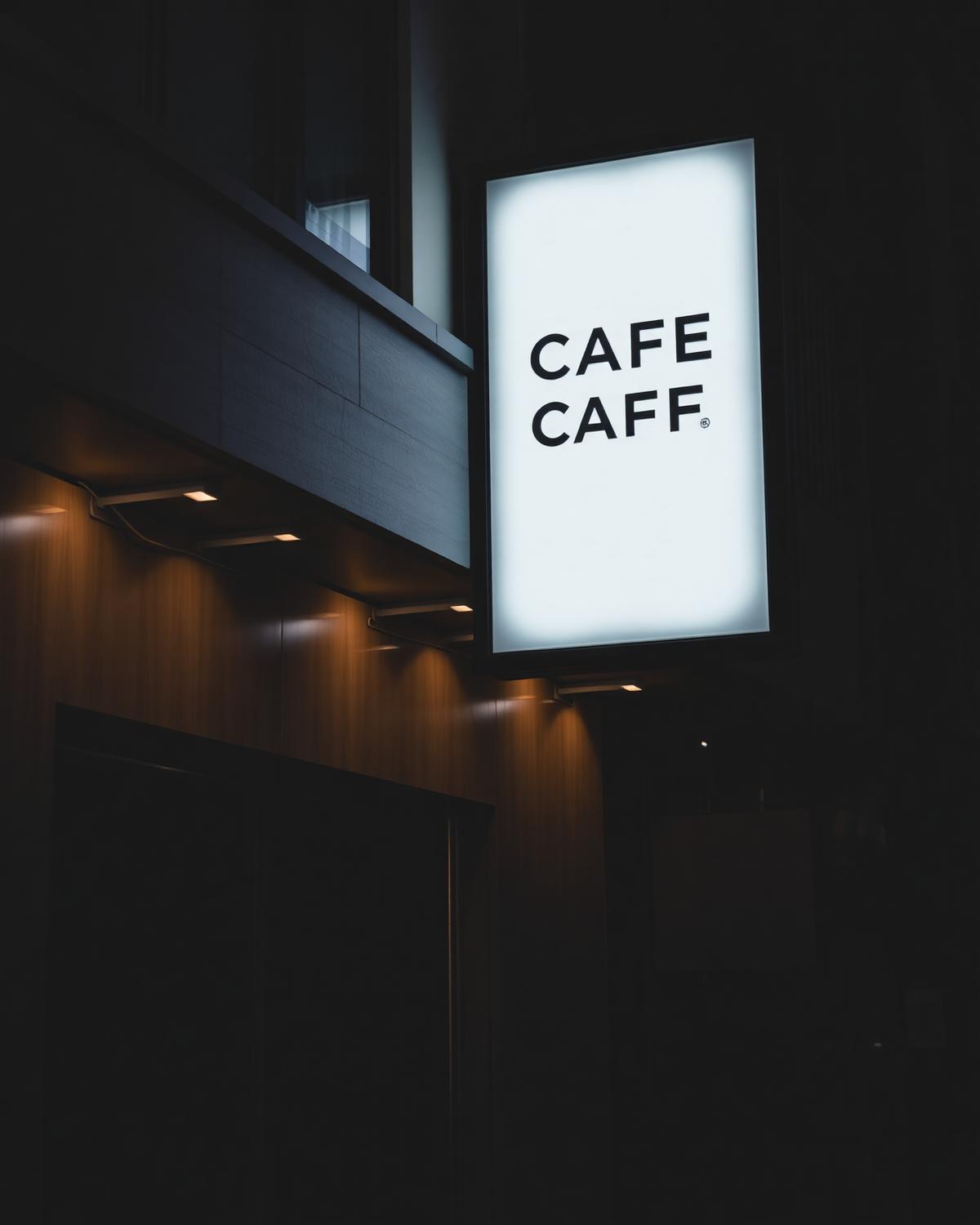 Glowing LED lightbox sign outside a café shopfront