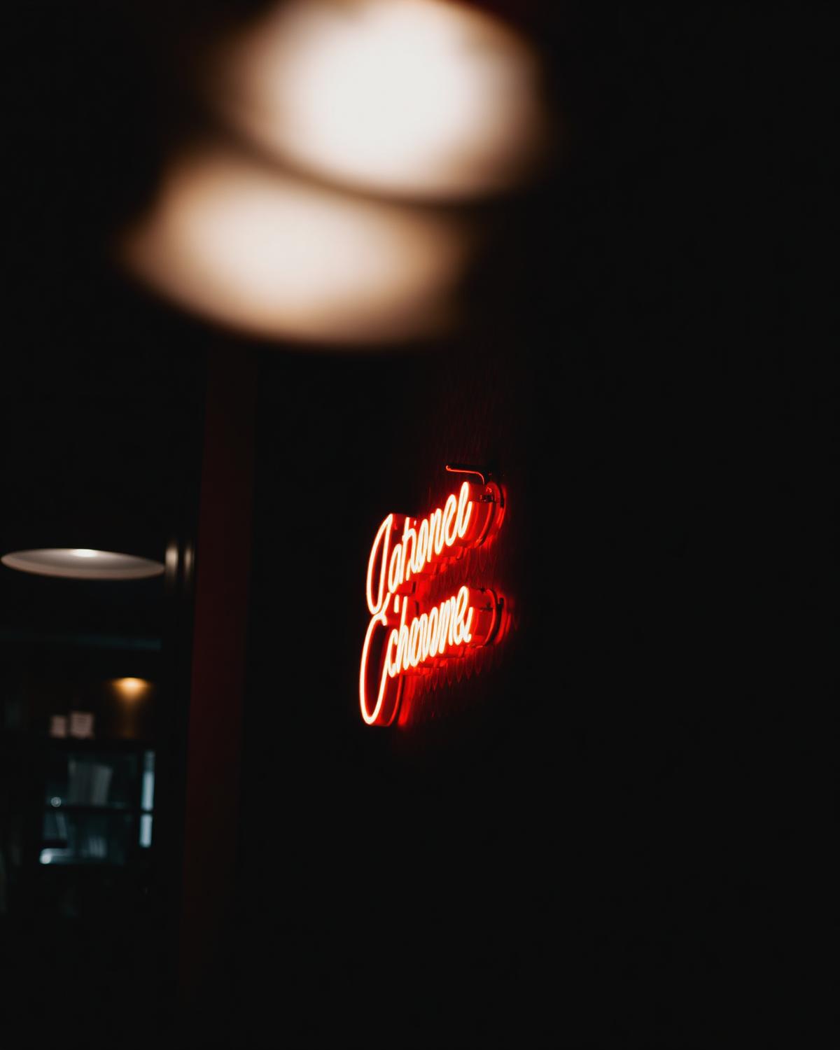 Warm LED neon sign glowing on a dark restaurant wall